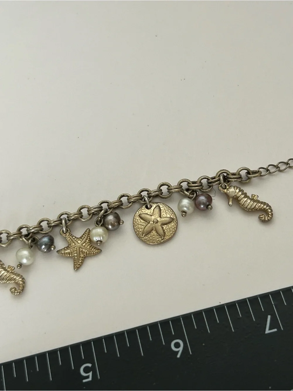 Gold-Tone Under the Sea Lia Sophia Seashell Charm Bracelet with Pearls (6) - Picture 2 of 6